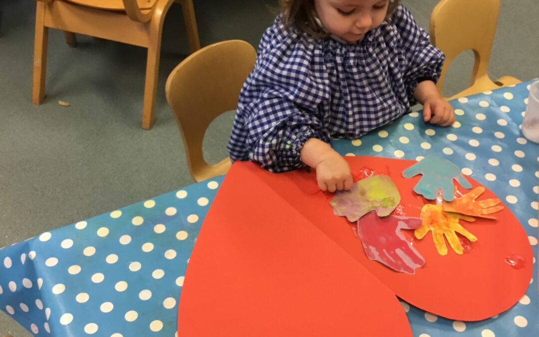 Caterpillar Class paint hearts for their kindness tree.