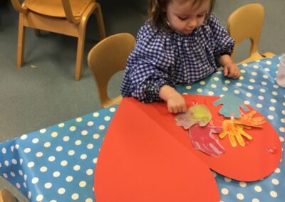 Caterpillar Class paint hearts for their kindness tree.