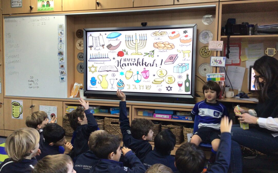 Year 1 sit on the carpet in the classroom and learn about Hannukah.