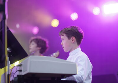 A KHS pupil plays the piano on stage at the summer concert.