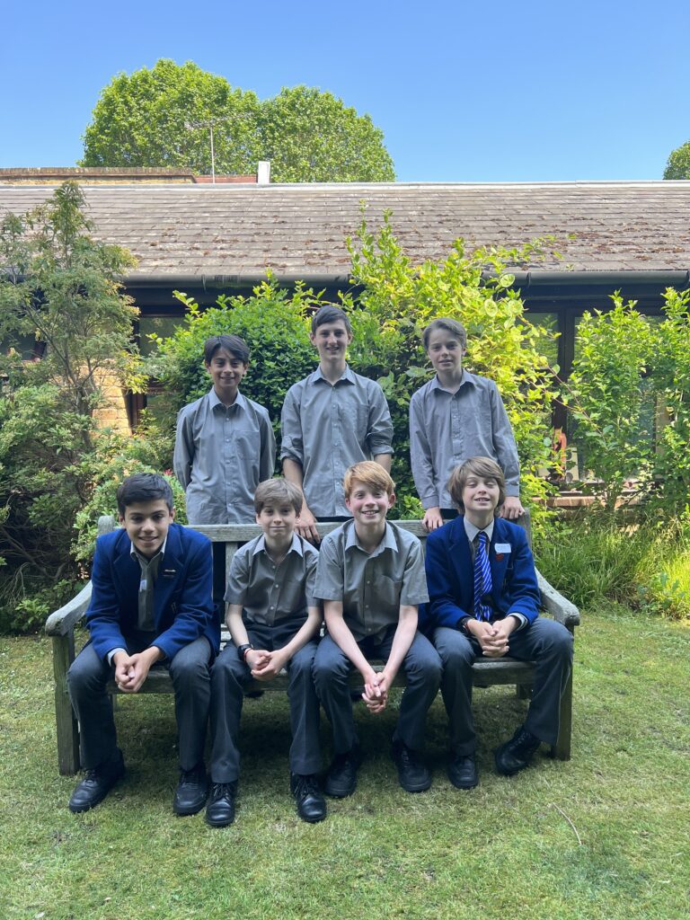 The seven Year 8 boys awarded scholarships to senior schools have their photo taken in the Head's Garden.