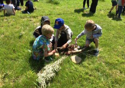 Year 1 pupils foraging for wood.